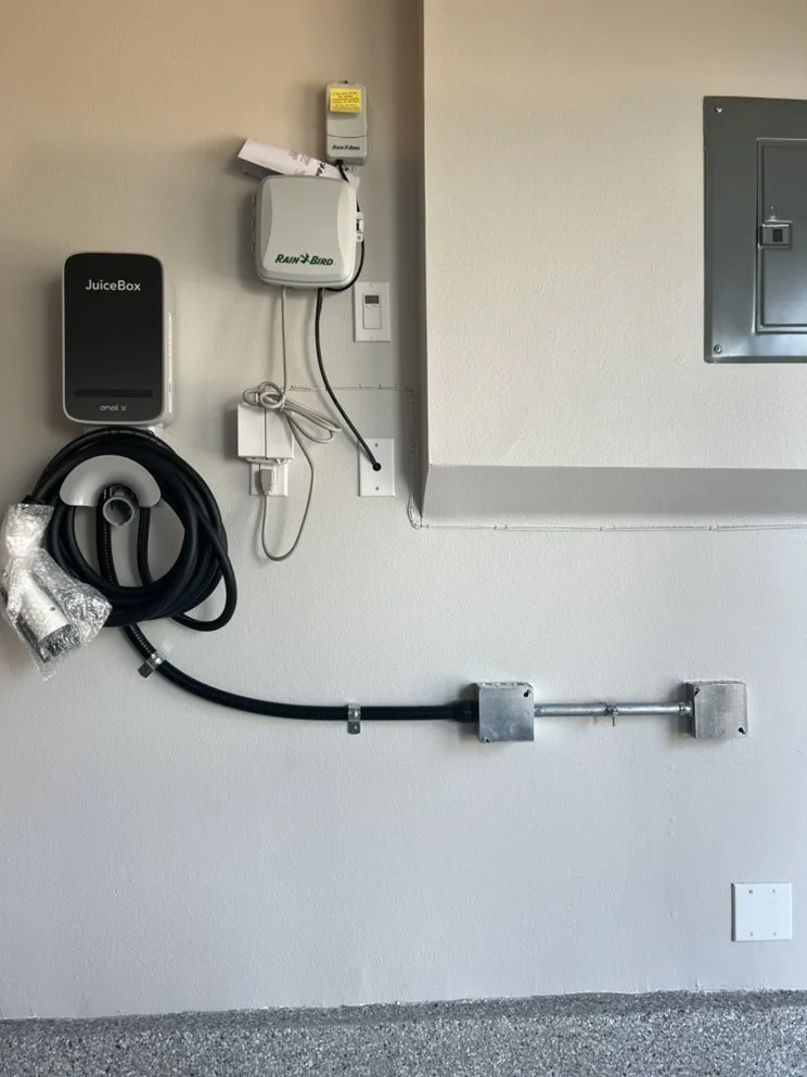 Wall-mounted electric vehicle charger with conduit