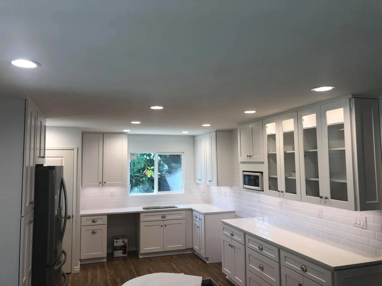 White kitchen with recessed lighting from Stay Grounded Electric’s website